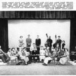 Quincy Jones sits with trumpet along with other students with instruments in the orchestra